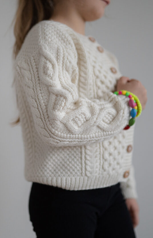 Children's knitted cardigan with braids