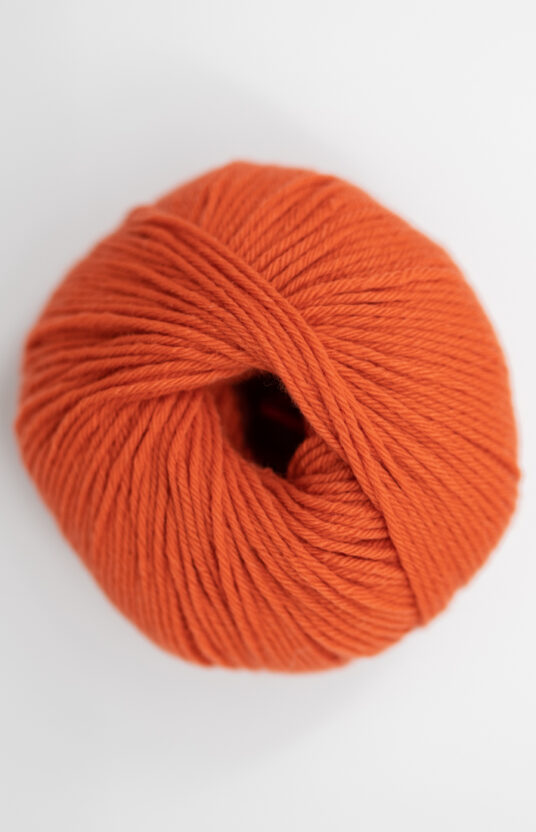 Merino yarn red orange color. Soft merino colorful yarn