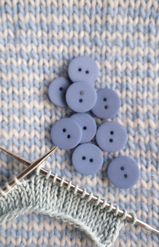 Buttons for cardigan in light blue color. Knobs for knitted cardigan, blue matte button with 2 holes